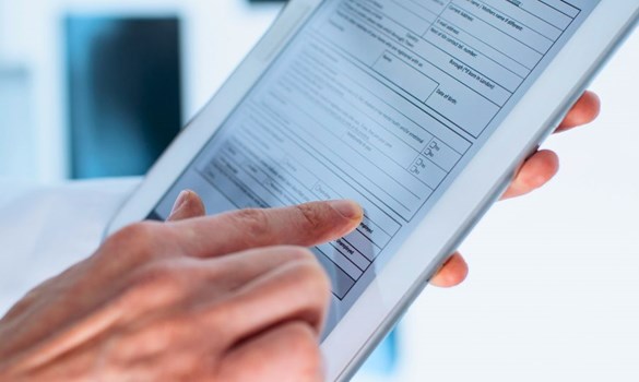 Close up of someone filling in a form on a tablet computer